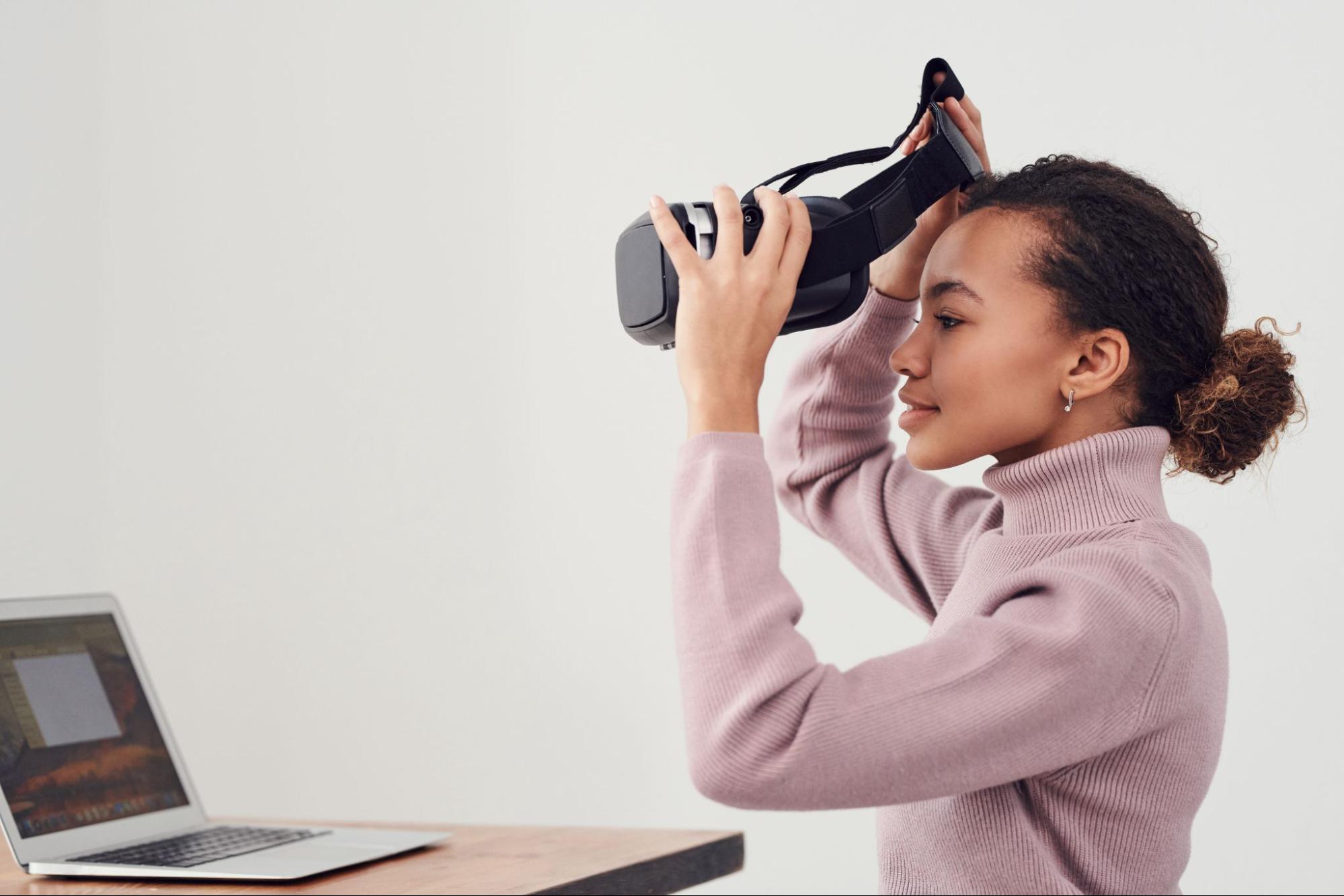 Woman putting on vr headset.